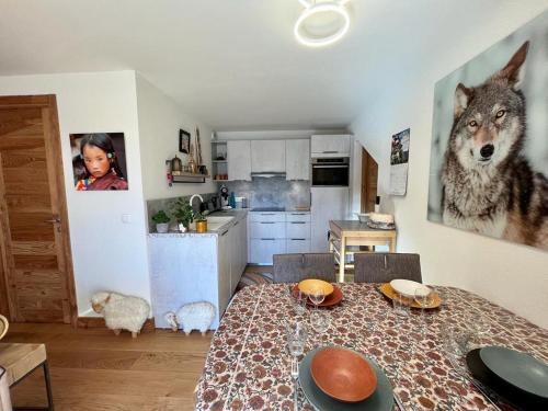 une cuisine avec une table et une photo de loup sur le mur dans l'établissement appartement Shangrila, à Chamonix-Mont-Blanc