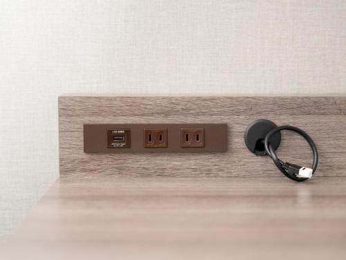 a lightswitch with a key on a wooden table at Super Hotel Premier Ikebukuro Natural Hot Spring in Tokyo