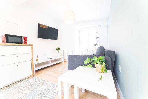 a living room with a couch and a table at Apartamento Balbín II in Gijón