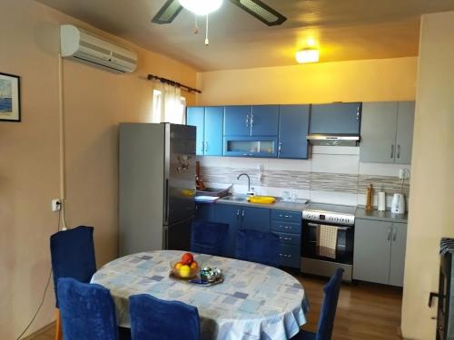 a kitchen with a table with a bowl of fruit on it at Apartment in Nin with Terrace, Air conditioning, Wi-Fi (3718-1) in Nin