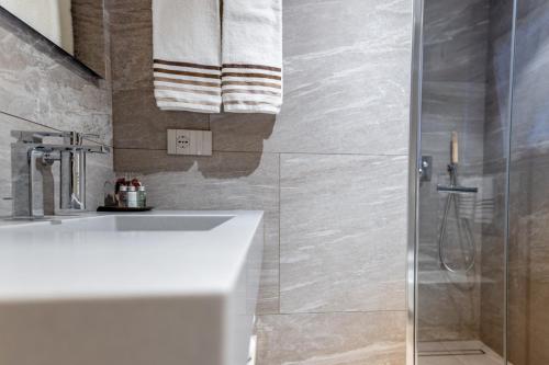 a bathroom with a sink and a shower at Chalet Imbosc'chè in Livigno