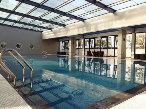 a large swimming pool with a glass ceiling at Thủy Hạ Long Homestay in Ha Long