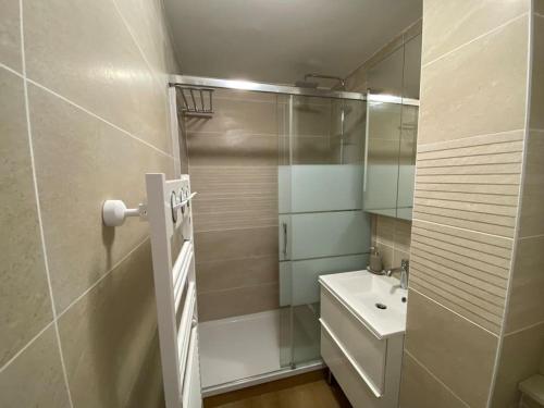 a white bathroom with a sink and a mirror at Sea-View - Wifi - Parking in Six-Fours-les-Plages