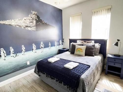a bedroom with a bed and a mural of a ship at 3BR Townhouse Next to Disney in Orlando