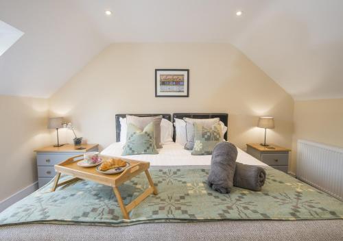a bedroom with a bed with a table on it at Hafod Aber in Rhyd-y-felin