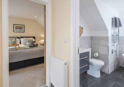 a bathroom with a bed and a toilet in a room at Hafod Aber in Rhyd-y-felin