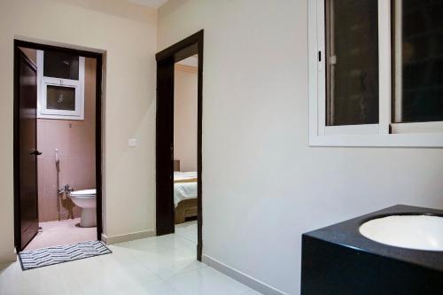 a bathroom with a sink and a toilet at Wasn Suites in Riyadh