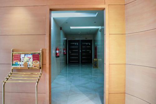 a hallway with a chair in front of a building at Wasn Suites in Riyadh