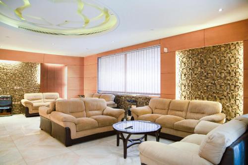 a large waiting room with couches and a table at Wasn Suites in Riyadh