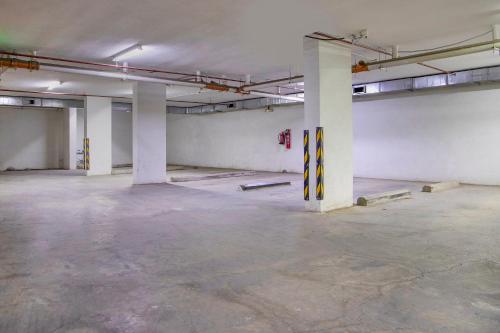 an empty parking garage with white walls and white columns at Wasn Suites in Riyadh