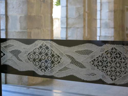 a white lace embroidery on the back of a bench at St Germain in Saint-Germain-du-Corbéis