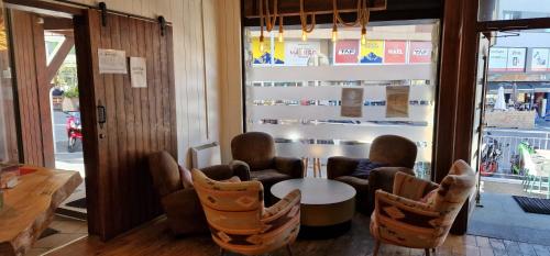 a room with chairs and a table in front of a window at Hotel Merino in Pas de la Casa