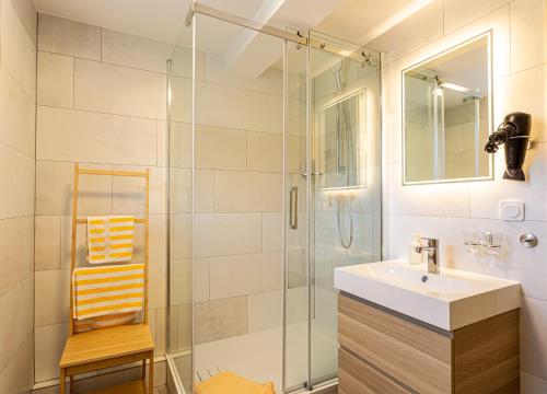 a bathroom with a sink and a shower at Landhotel Gutshof in Hartenstein