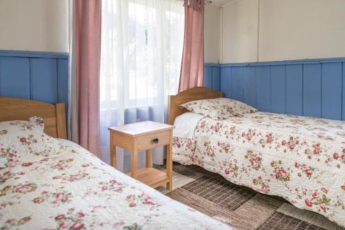 1 Schlafzimmer mit 2 Betten und einem Fenster in der Unterkunft La Casona, baño Compartido in Villa Cerro Castillo
