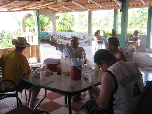 a group of people sitting around a table at El Mirador Ecológico, Ometepe in Altagracia
