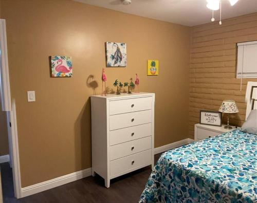 a bedroom with a white dresser and a bed at Relaxing River Family Retreat in Bullhead City