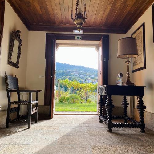 a room with a door with a view of a yard at Casa de Santa Bárbara - Cinfães in Cinfães