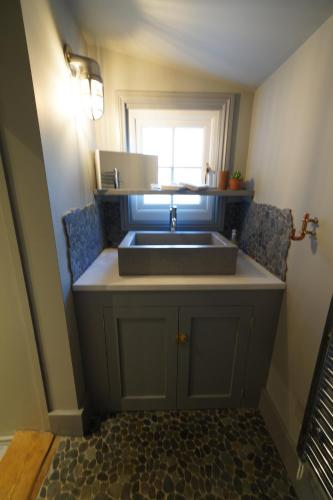 a kitchen with a sink and a window at Walmer, Deal stunning coach house apartment in Walmer