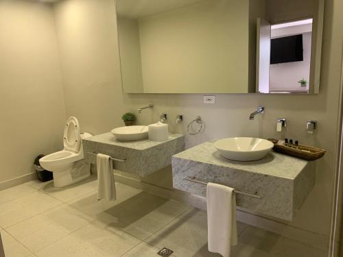 a bathroom with two sinks and a toilet at Madisson Boutique Hotel Cartagena in Cartagena de Indias