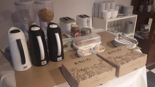 a counter top with two bottles and plates on it at Hotel Costanera in Formosa