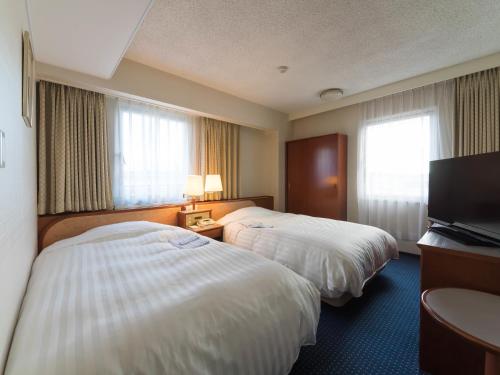 Postel nebo postele na pokoji v ubytování Hotel Matsunoka Ichinoseki