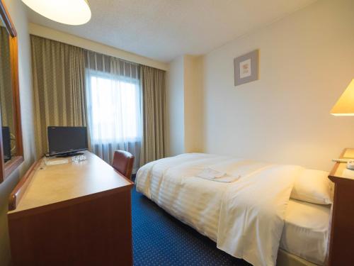 Postel nebo postele na pokoji v ubytování Hotel Matsunoka Ichinoseki