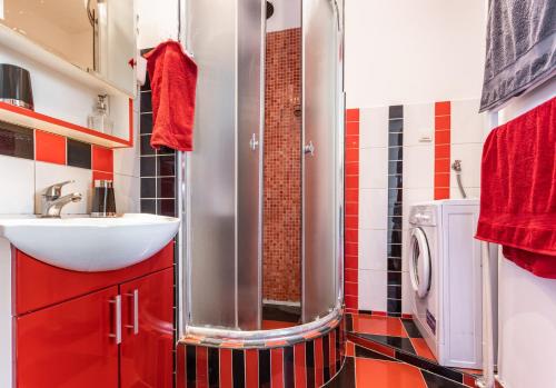 a bathroom with a shower and a sink and a washing machine at Spacious Loft with one bedroom and a big terrace in Belgrade