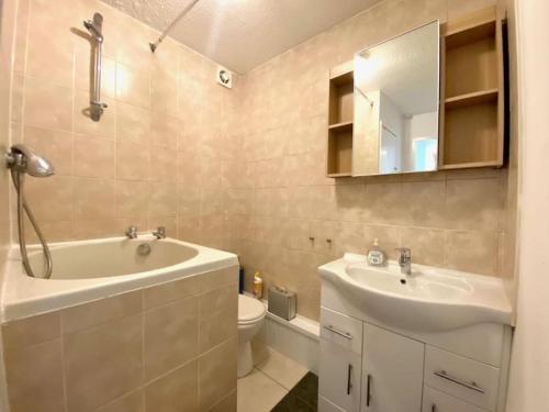 Un baño con lavabo, bañera e inodoro. en Lovely Apt in City Centre Leeds, en Leeds