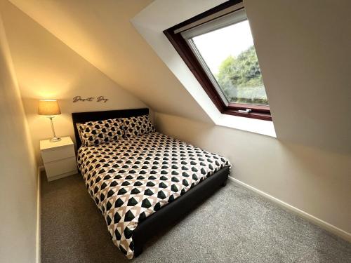 a bedroom with a bed and a window at Modern 2 Bedroom, 2 Bathroom Home with Parking in Stanley