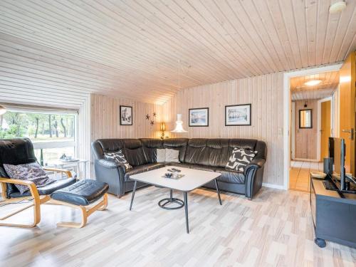 a living room with a couch and a table at Bright Cottage with Covered Terrace-By Traum in Nørre Nebel