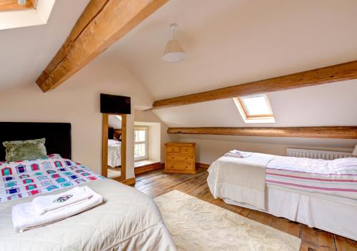 a bedroom with two beds in a attic at Rhiwlas in Pennal