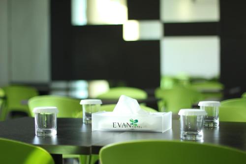 a table with a napkin and glasses on it at Evan Hotel Jambi in Jambi