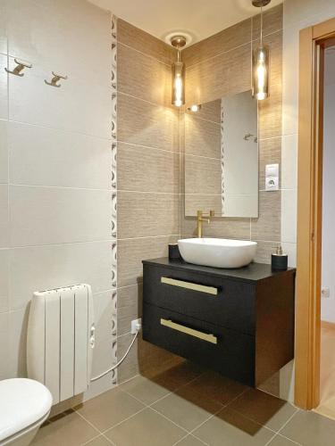 a bathroom with a sink and a mirror at Apartamento Valle de Alba in Benasque