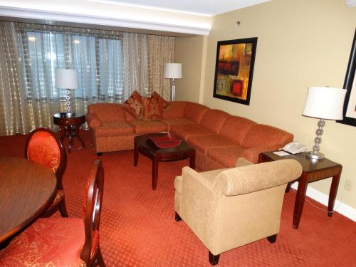 a living room with a couch and a table at Suites at Jockey Club (No Resort Fee) in Las Vegas