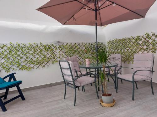 a patio with a table and chairs with an umbrella at Apartments in Central Lisbon in Lisbon