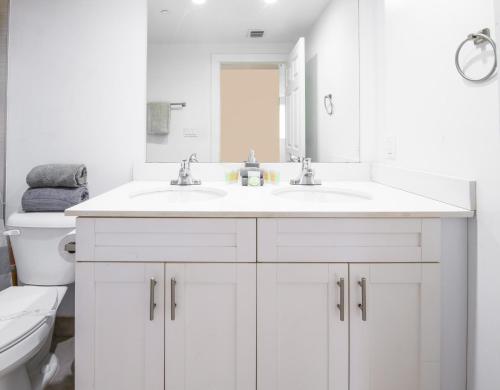 a white bathroom with a sink and a toilet at Spacious entire Apartment with Free Parking in Hollywood