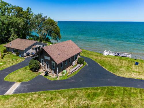 an aerial view of a house on the water at Cozy Lakefront Cottage in Huron