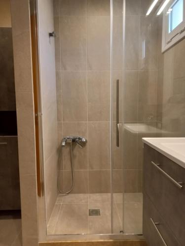 a shower with a glass door in a bathroom at Peaceful Villa With Nice View in Agios Nikolaos