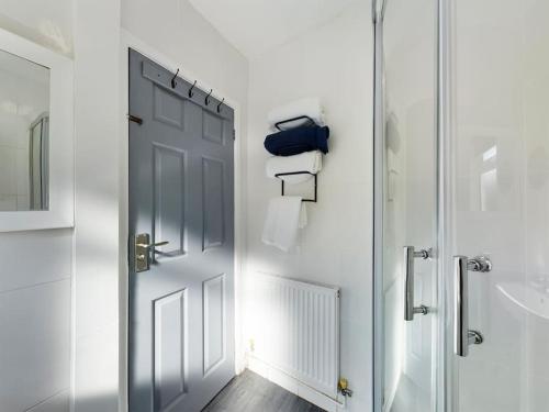 a white bathroom with a door and a sink at Whitmore House By RMR Accommodations - Newly Refurbed - Modern - Parking - Central in Etruria