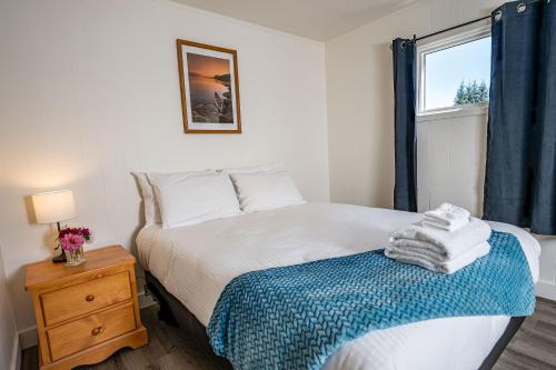 a small bedroom with a bed and a window at Downie Cottage by Revelstoke Vacations in Revelstoke