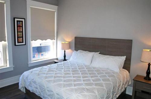 a bedroom with a large bed and two windows at Cornerstone Inn in Washington