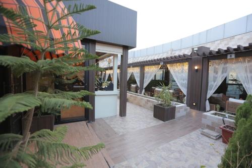 a building with a patio with plants on it at Broad Almkan Apart Hotel in Taif