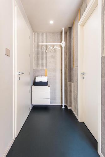 a corridor of a room with a bed and a door at Open Hotel in Rimini