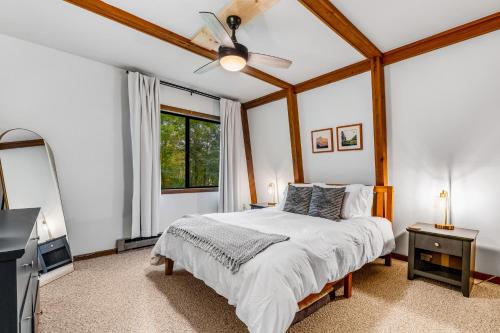 a bedroom with a bed and a ceiling fan at Laurel Haven in Banner Elk