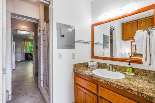 a bathroom with a sink and a mirror at Prince Kuhio 319 in Koloa