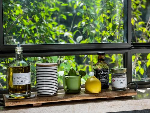 a shelf with bottles and dishes on a window sill at חופשה בחורשה in Sha'al
