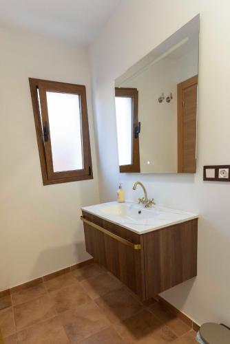 a bathroom with a sink and a mirror at PLA DE LA CASA in Cuatretondeta