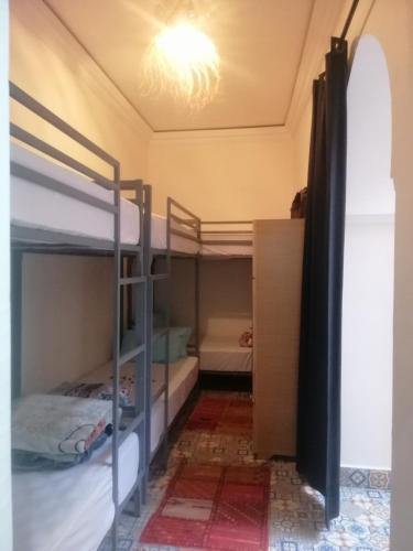 a bedroom with two bunk beds in a room at Hostel Laksour in Marrakech