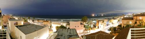 a view of a city at night with the ocean at Beautiful Views - Sand Section of Manhattan Beach 2 Bed/2 Bath in Manhattan Beach