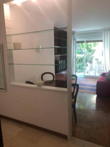 een woonkamer met een aanrecht en een kamer met een raam bij GUISCI BEACH HOUSE - 10 Passi dalla spiaggia in Sanremo
